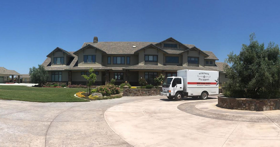 Simpson plumbing truck parked outside a large home in Mountain House