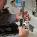 plumber fixing kitchen sink